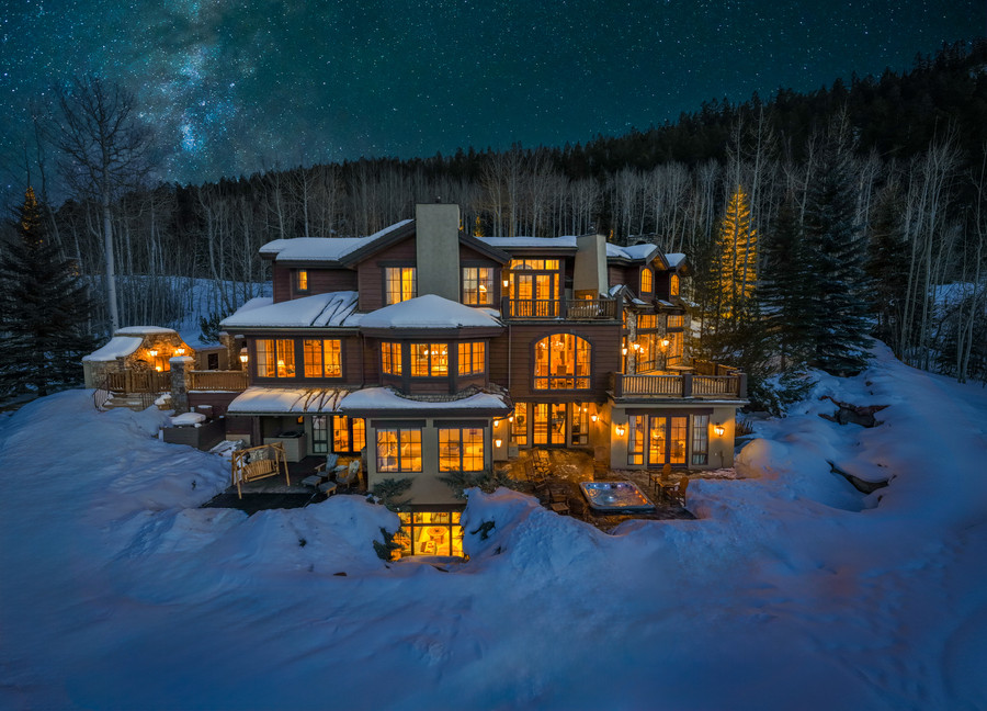 The Lodge at Aspen Highlands lit at night in deep snow